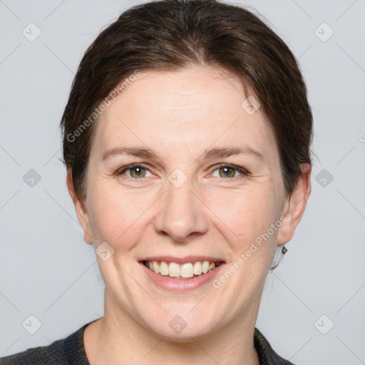 Joyful white adult female with medium  brown hair and grey eyes