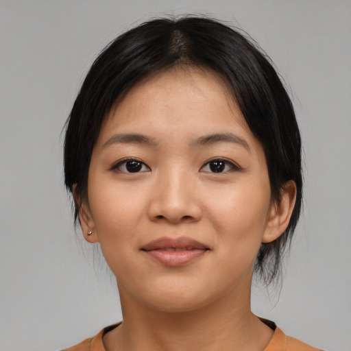 Joyful asian young-adult female with medium  brown hair and brown eyes
