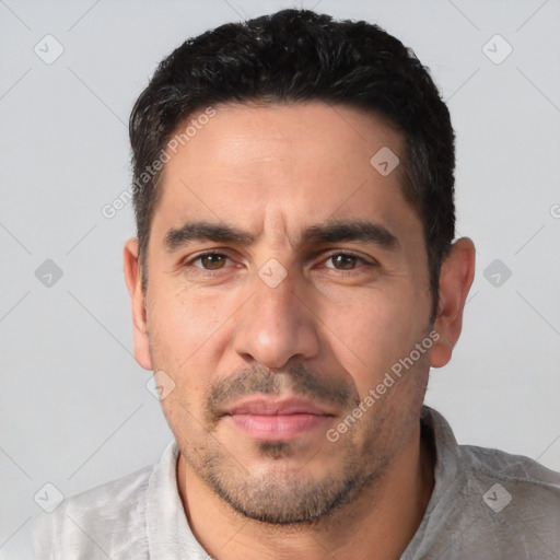 Joyful white adult male with short  black hair and brown eyes