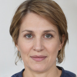 Joyful white adult female with medium  brown hair and grey eyes