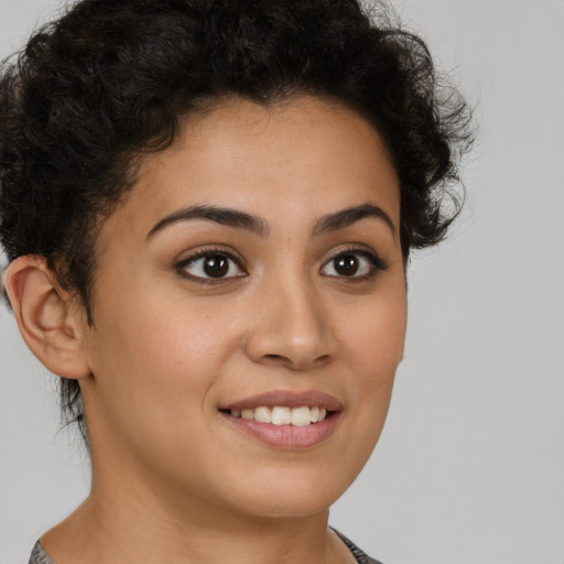 Joyful latino young-adult female with short  brown hair and brown eyes