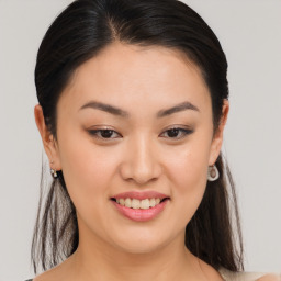 Joyful asian young-adult female with long  brown hair and brown eyes