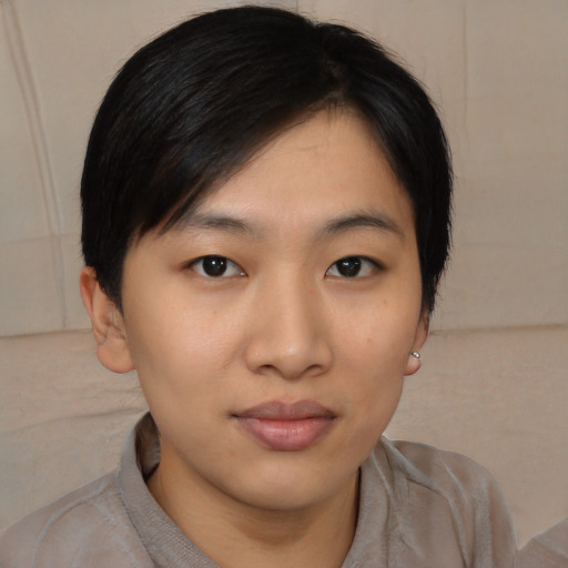 Joyful asian young-adult female with medium  black hair and brown eyes