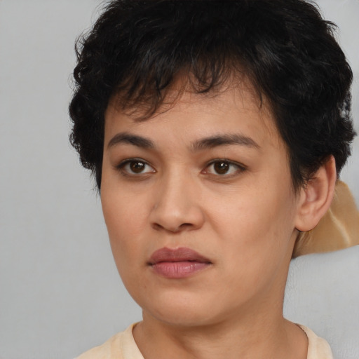 Joyful asian young-adult female with short  brown hair and brown eyes