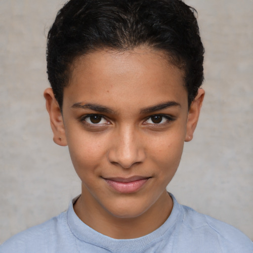 Joyful latino child female with short  brown hair and brown eyes