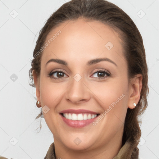 Joyful white young-adult female with long  brown hair and brown eyes