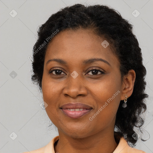 Joyful black adult female with long  brown hair and brown eyes