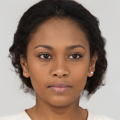 Neutral black young-adult female with long  brown hair and brown eyes