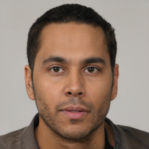 Neutral latino young-adult male with short  black hair and brown eyes