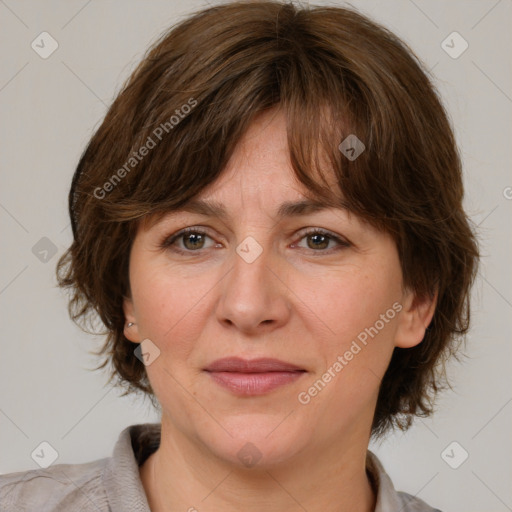 Joyful white adult female with medium  brown hair and grey eyes