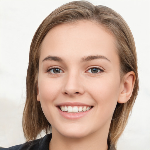 Joyful white young-adult female with long  brown hair and blue eyes