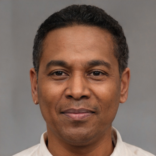 Neutral latino adult male with short  black hair and brown eyes