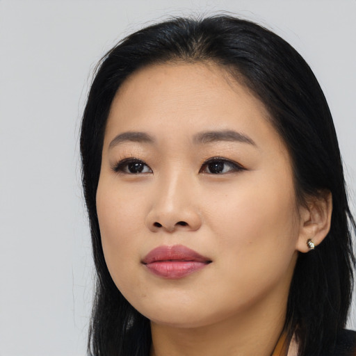 Joyful asian young-adult female with long  black hair and brown eyes