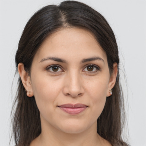 Joyful white young-adult female with long  brown hair and brown eyes