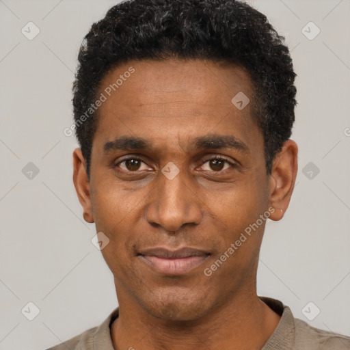 Joyful black adult male with short  black hair and brown eyes