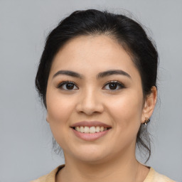 Joyful latino young-adult female with medium  brown hair and brown eyes