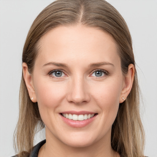 Joyful white young-adult female with long  brown hair and grey eyes