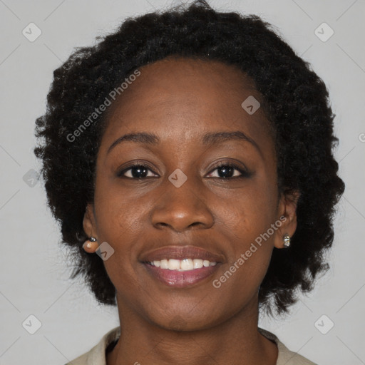 Joyful black adult female with medium  brown hair and brown eyes