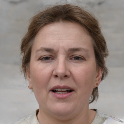 Joyful white adult female with medium  brown hair and grey eyes