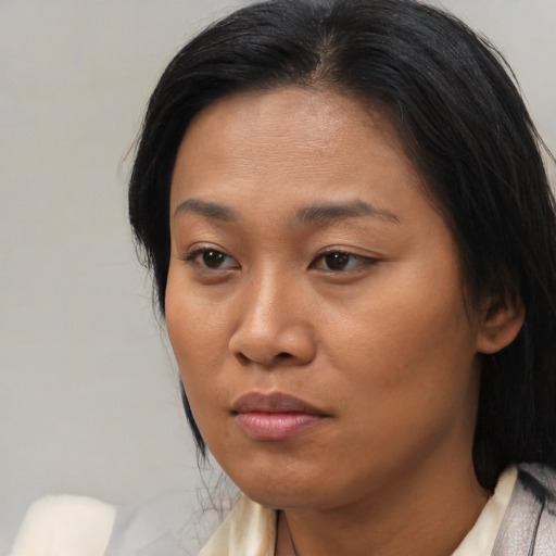 Neutral asian young-adult female with medium  brown hair and brown eyes