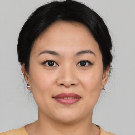 Joyful asian young-adult female with medium  brown hair and brown eyes