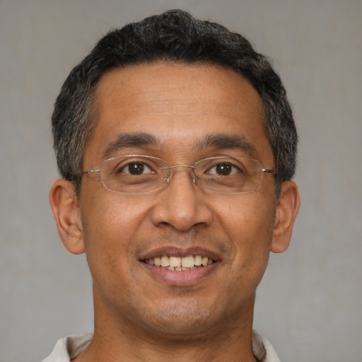 Joyful asian adult male with short  black hair and brown eyes
