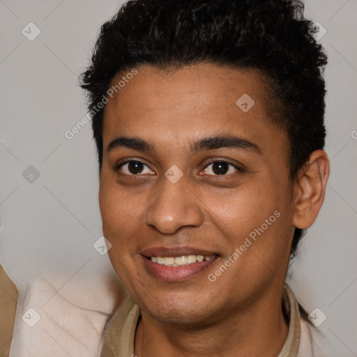 Joyful black young-adult male with short  brown hair and brown eyes