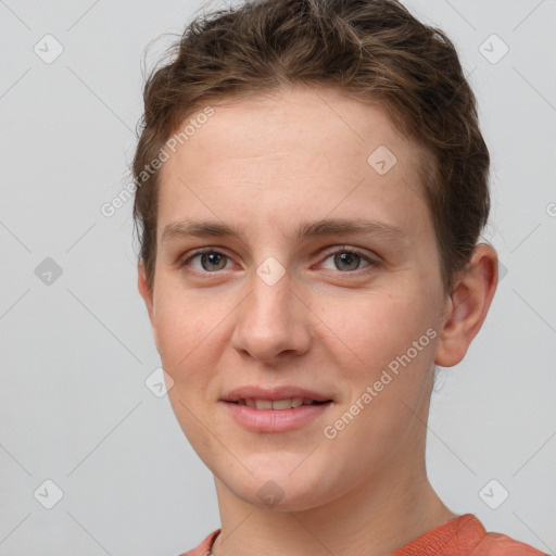 Joyful white young-adult female with short  brown hair and grey eyes