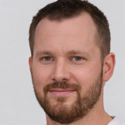 Joyful white adult male with short  brown hair and brown eyes