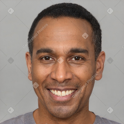 Joyful latino adult male with short  black hair and brown eyes