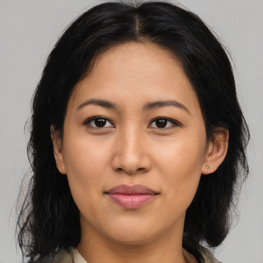 Joyful latino young-adult female with medium  black hair and brown eyes