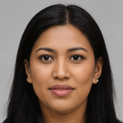 Joyful latino young-adult female with long  black hair and brown eyes