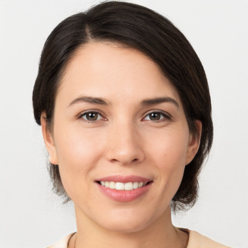 Joyful white young-adult female with medium  brown hair and brown eyes