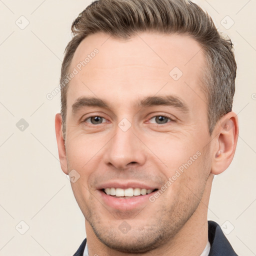 Joyful white young-adult male with short  brown hair and brown eyes