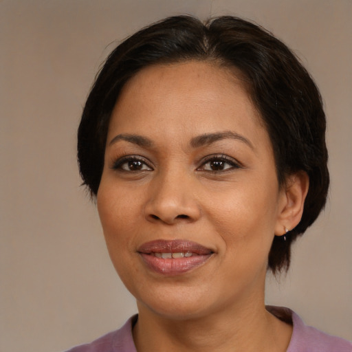 Joyful latino adult female with medium  brown hair and brown eyes