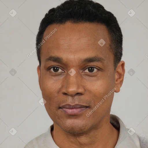 Joyful black young-adult male with short  black hair and brown eyes