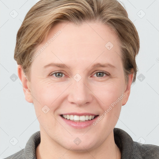 Joyful white adult female with short  brown hair and grey eyes