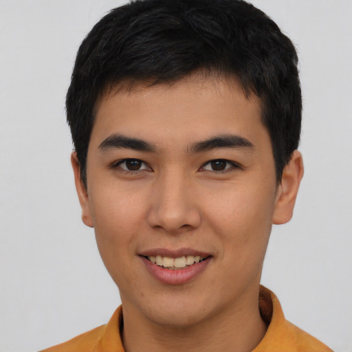 Joyful asian young-adult male with short  black hair and brown eyes