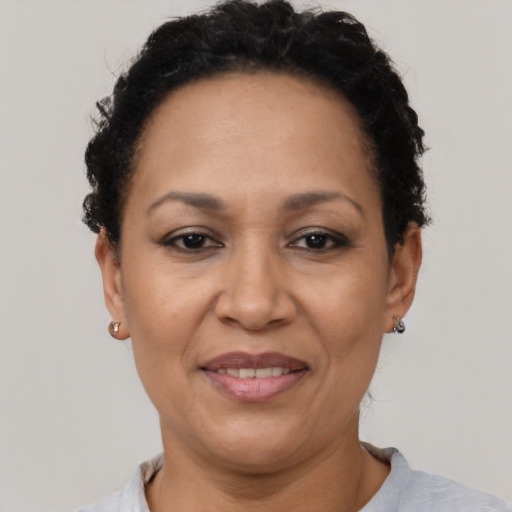 Joyful latino adult female with short  brown hair and brown eyes