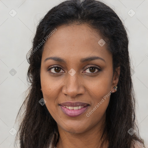 Joyful black young-adult female with long  brown hair and brown eyes