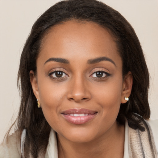 Joyful latino young-adult female with long  brown hair and brown eyes