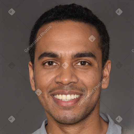 Joyful black young-adult male with short  black hair and brown eyes