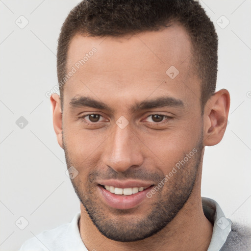 Joyful white young-adult male with short  brown hair and brown eyes