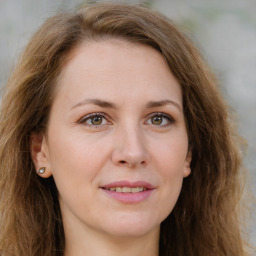 Joyful white young-adult female with long  brown hair and green eyes