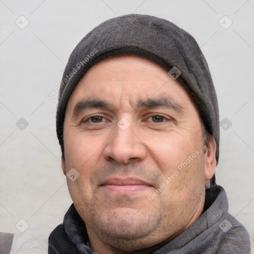 Joyful white adult male with short  black hair and brown eyes