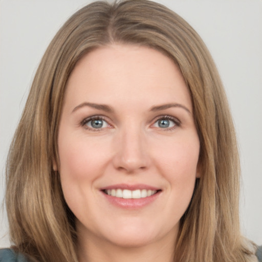 Joyful white young-adult female with long  brown hair and green eyes