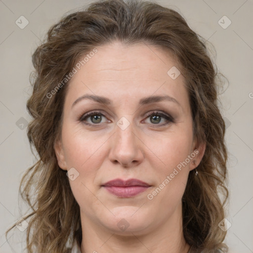 Joyful white adult female with medium  brown hair and green eyes