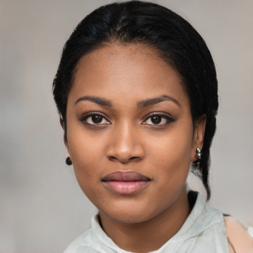 Joyful black young-adult female with medium  black hair and brown eyes