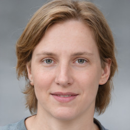 Joyful white young-adult female with medium  brown hair and blue eyes