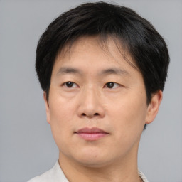 Neutral asian adult male with short  brown hair and brown eyes